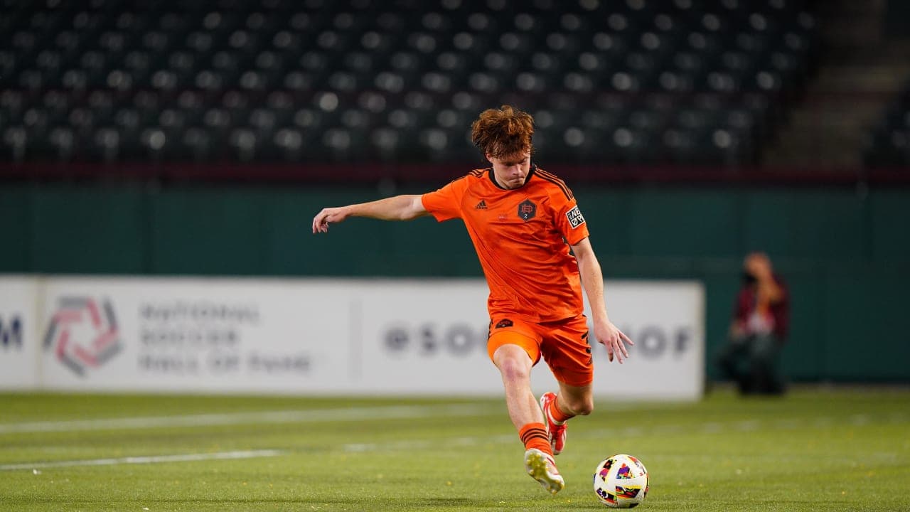 Player kicking the ball during MLS Next Pro match