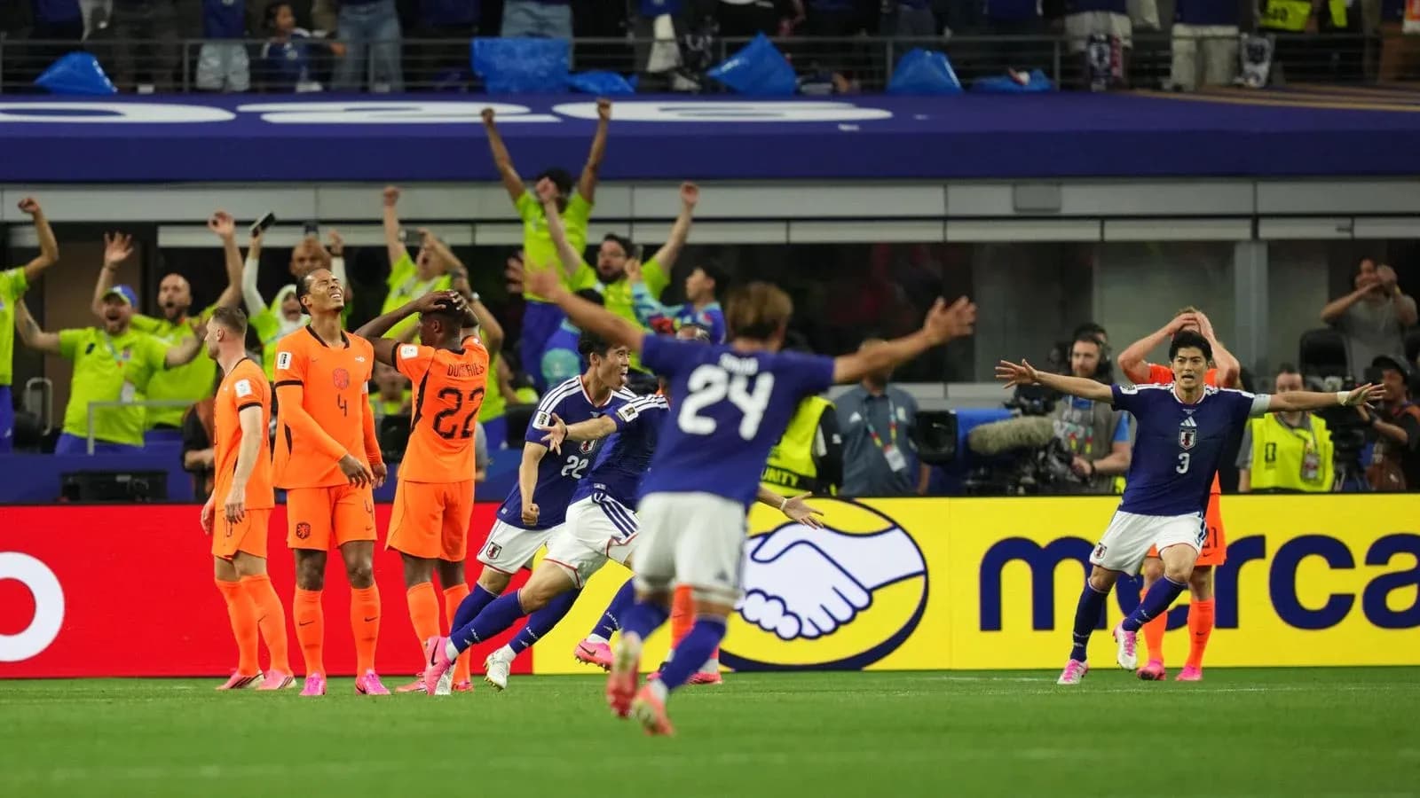 Japanese players celebrating goal against Netherlands
