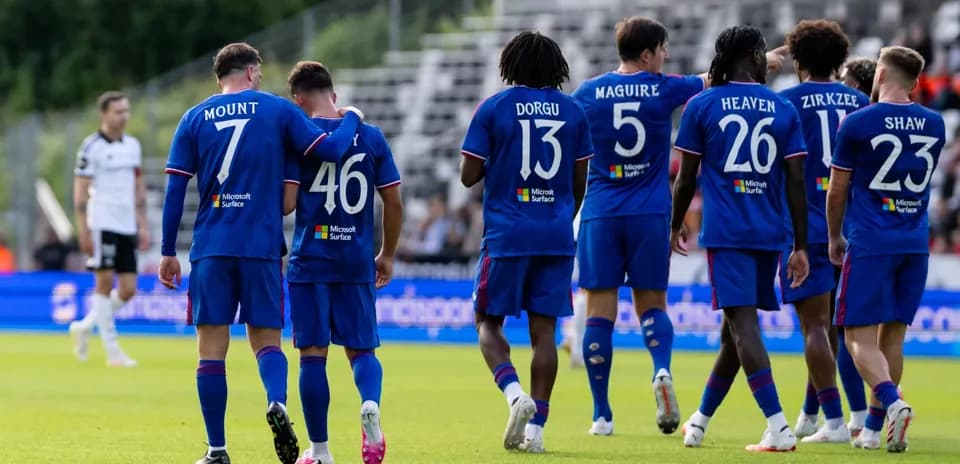 Players celebrating a goal on the field