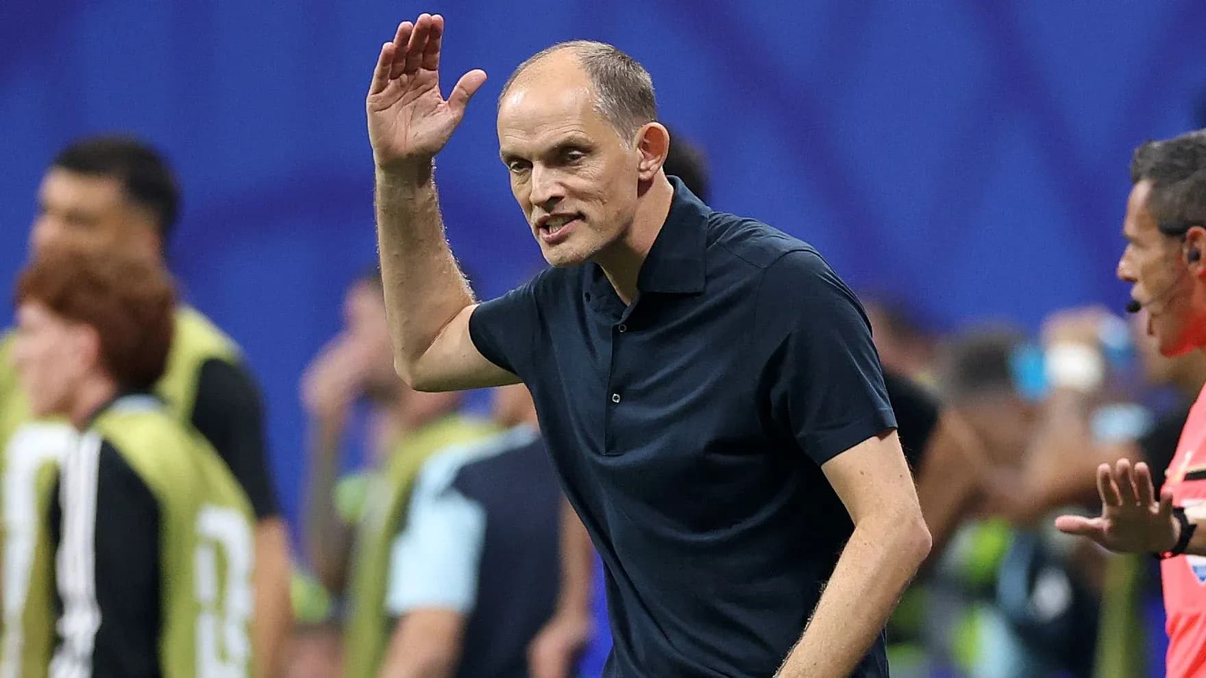 Coach gesturing during a match from the sidelines