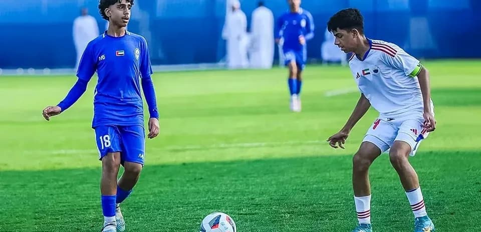Two players competing in U23 football match