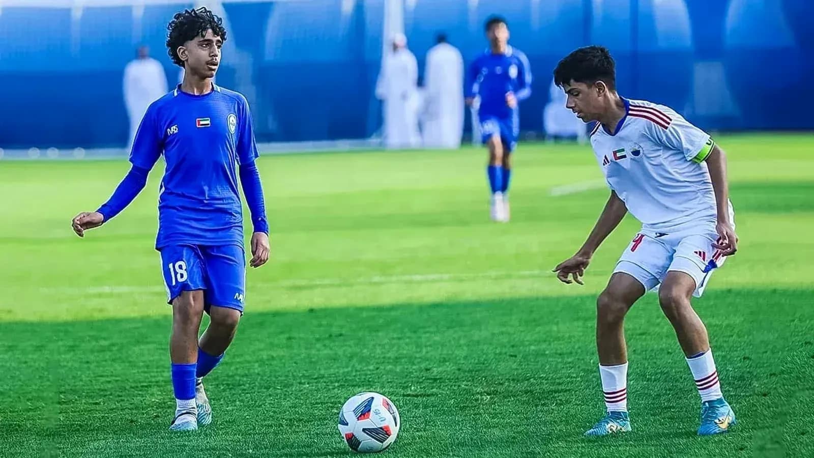 Two players competing in U23 football match