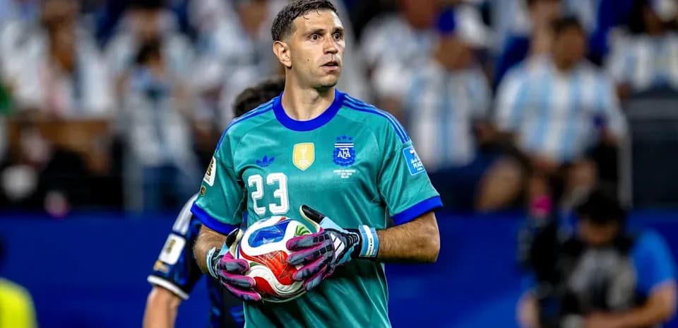 Goalkeeper holding ball during match in stadium