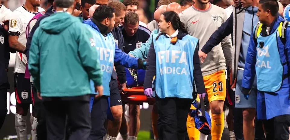 Medical team assisting injured player off the field