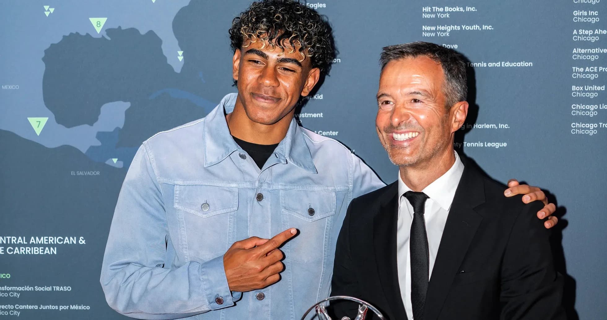 Two men posing with an award at event