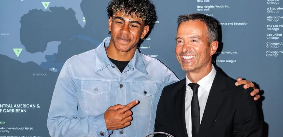 Two men posing with an award at event