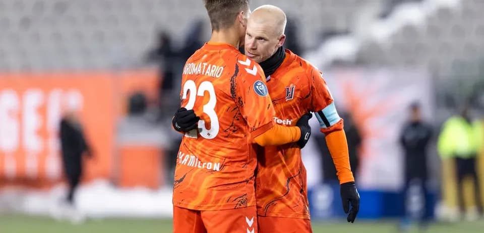 Two players embracing on the pitch