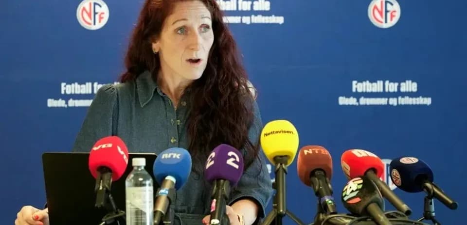 Speaker at press conference with microphones displayed