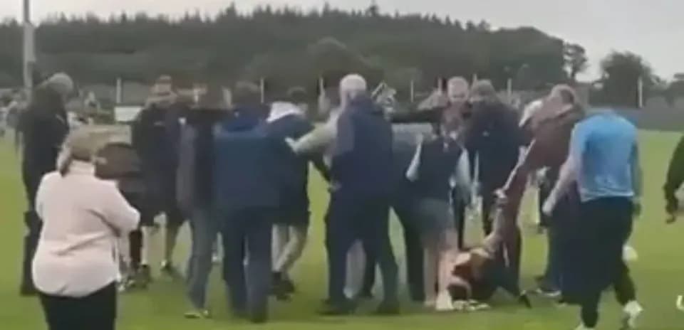 Crowd of people gathered on sports field