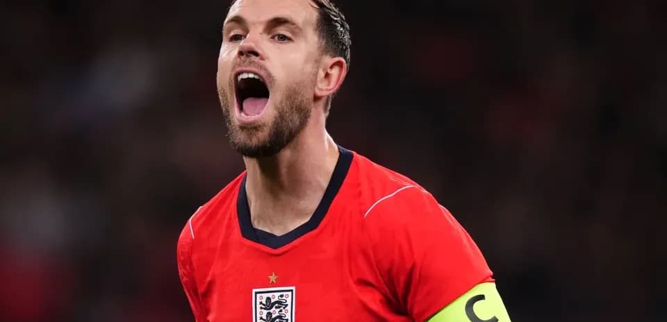 Player in red England jersey celebrating passionately