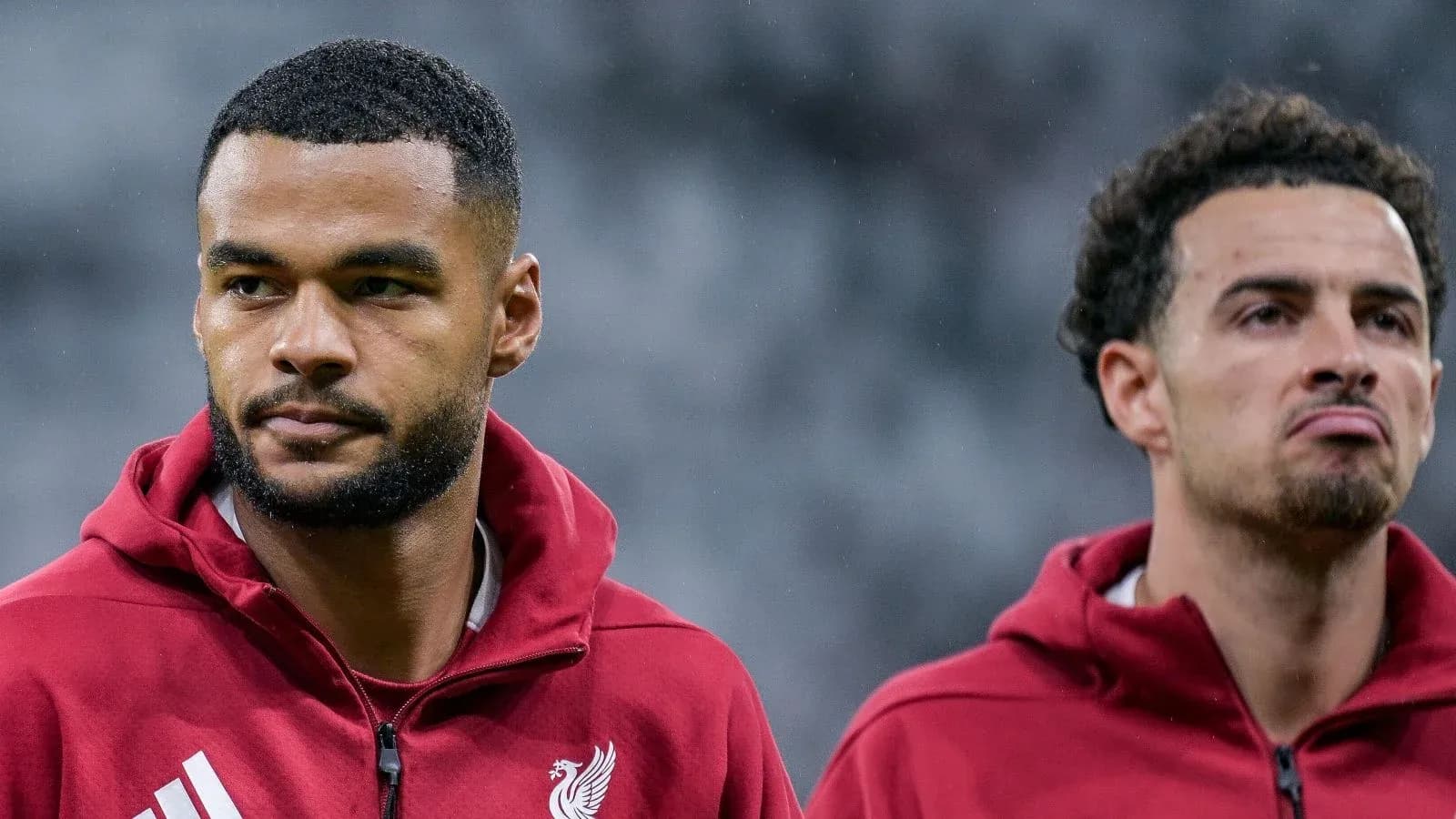 Two Liverpool players in training jackets before match