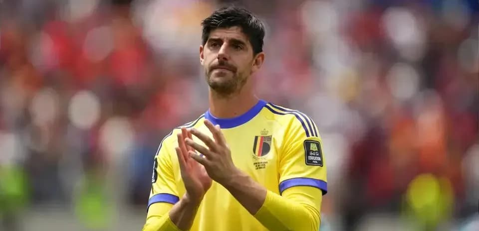 Goalkeeper in yellow jersey applauding fans