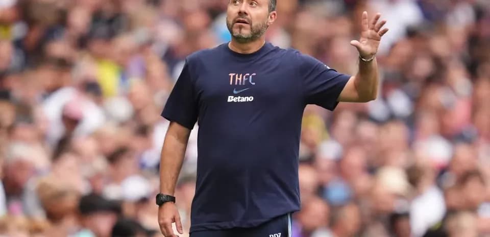 Manager gesturing on the sideline during match