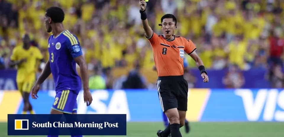 Referee showing yellow card to player during match