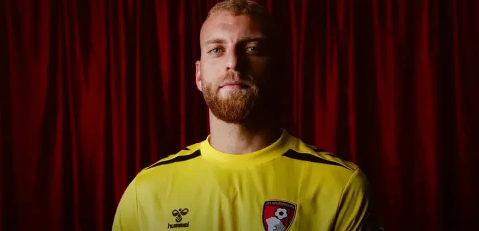 Goalkeeper wearing yellow jersey with AFC Bournemouth logo