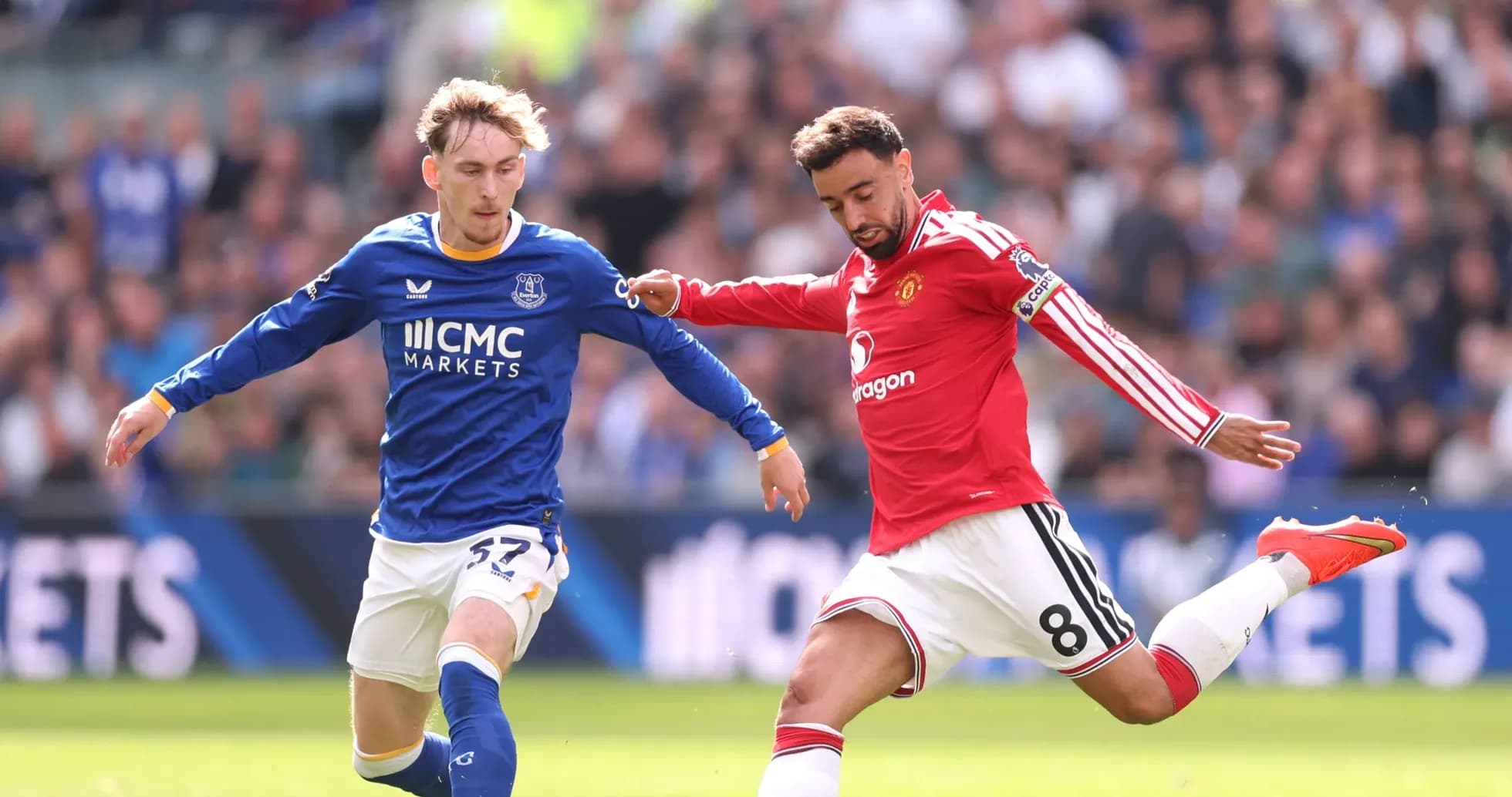 Everton and Manchester United players competing for ball