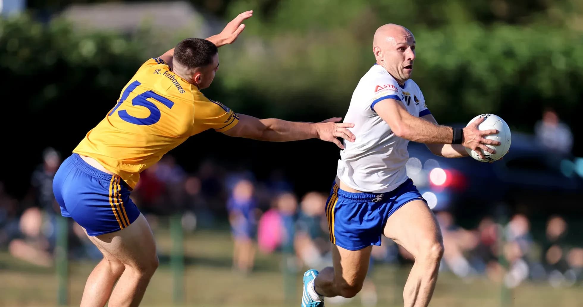 Player running with ball while being chased by opponent