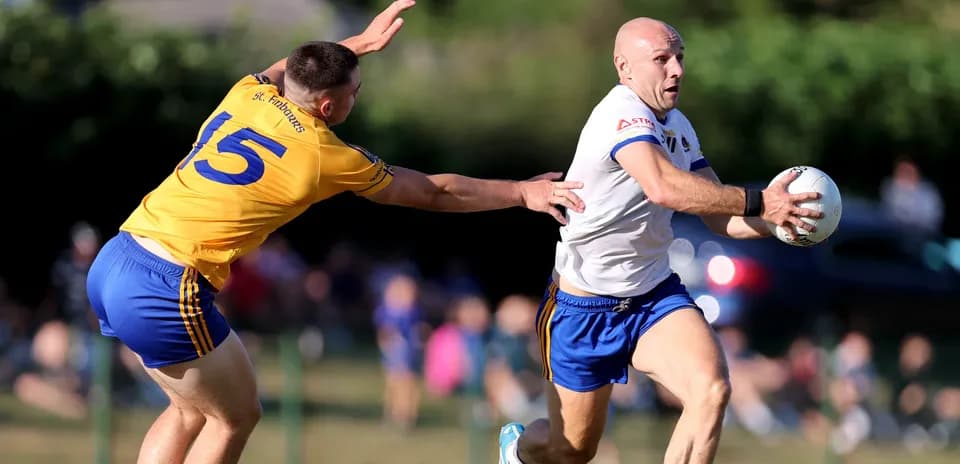 Player running with ball while being chased by opponent