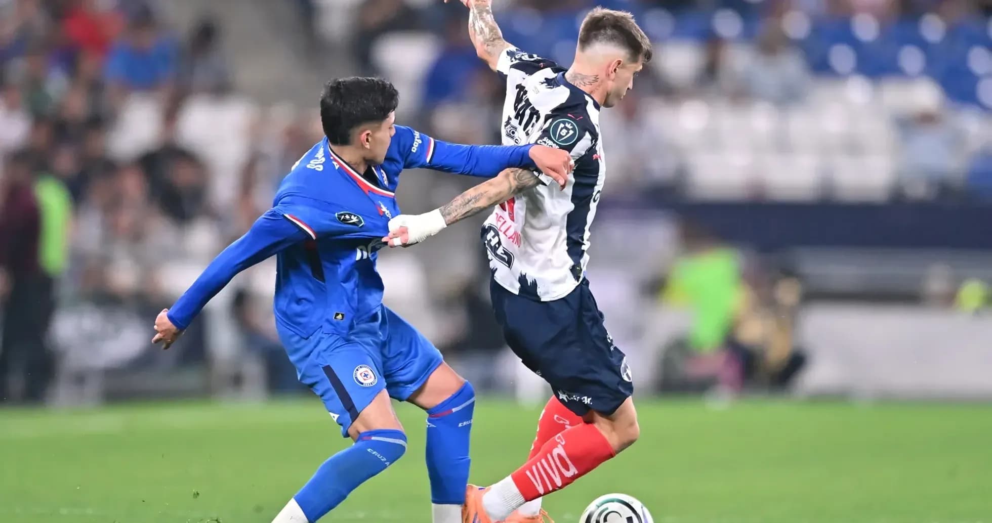 Monterrey player challenged by Cruz Azul opponent