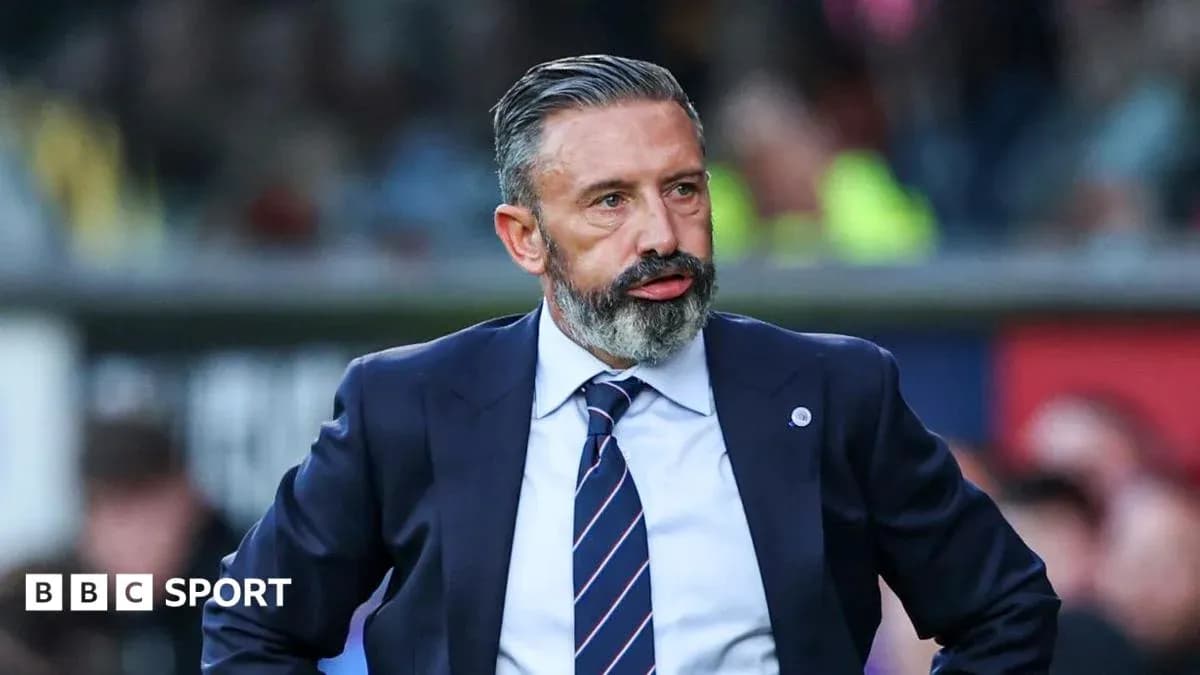 Football manager standing on the sidelines during match
