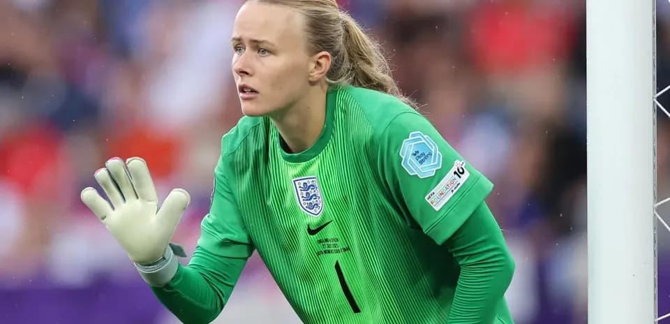 Goalkeeper in green jersey preparing for action