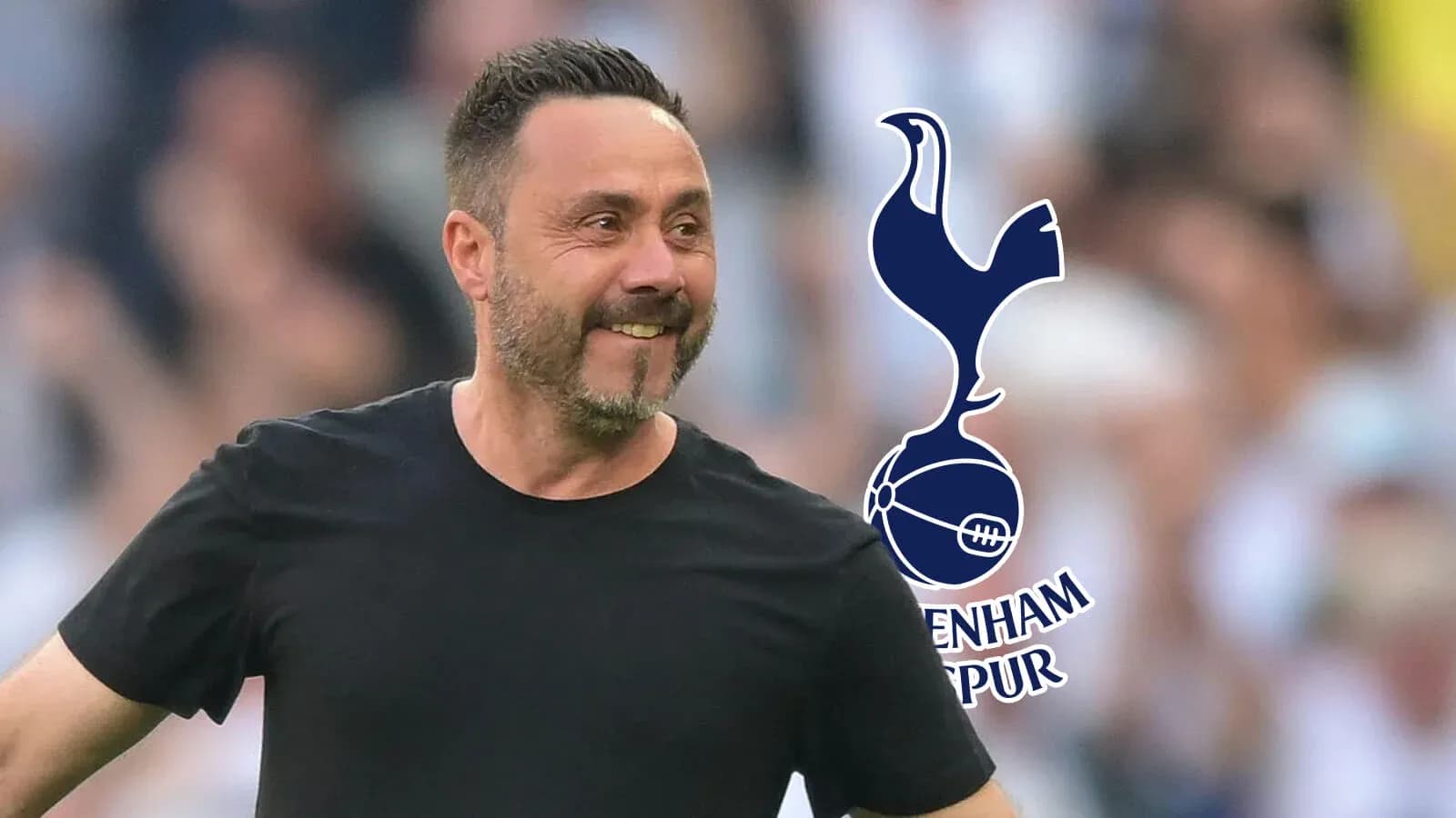 Manager smiling on the pitch with Tottenham logo