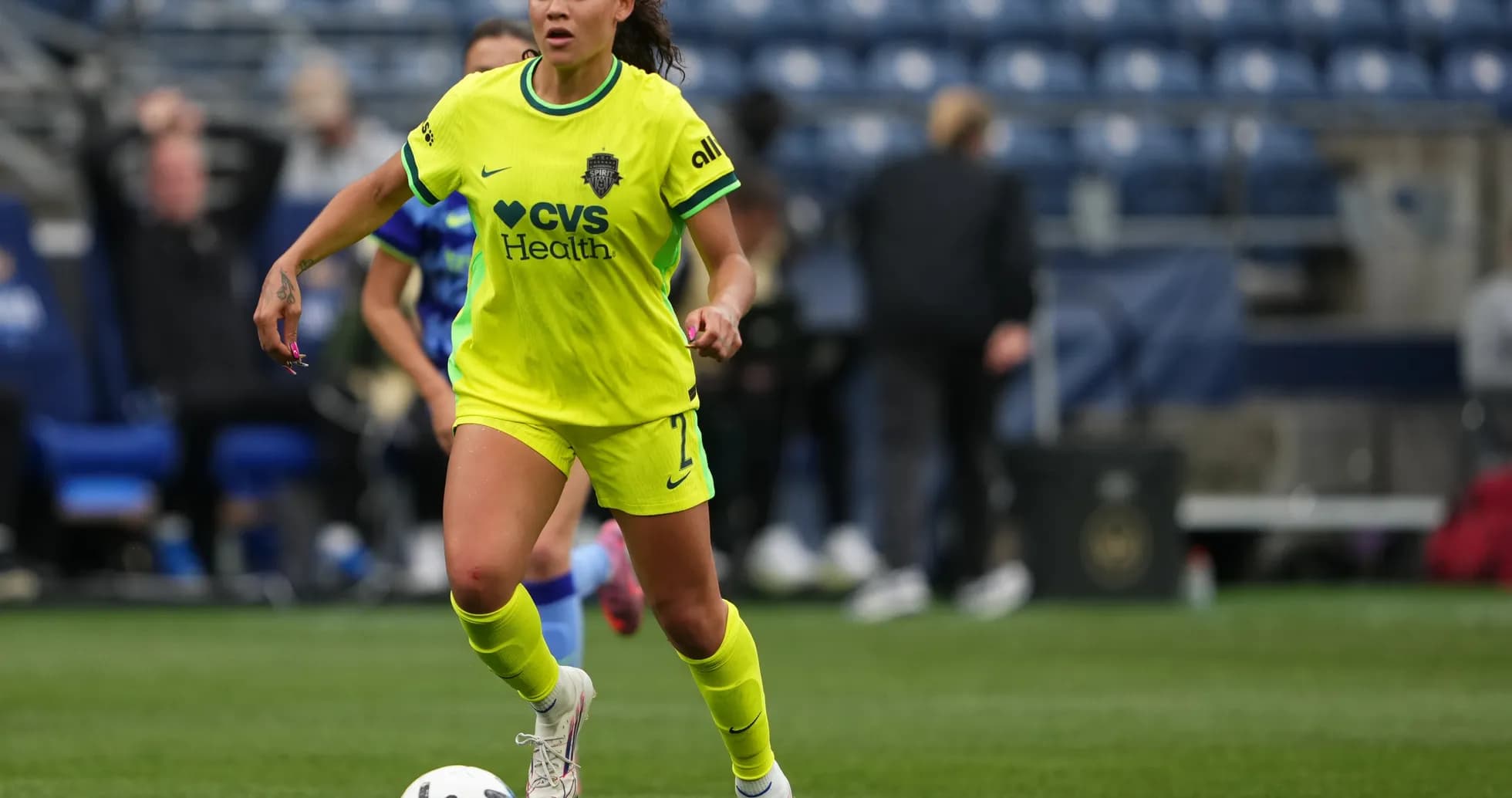 Player dribbling the ball in bright uniform