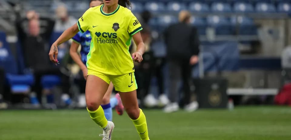 Player dribbling the ball in bright uniform