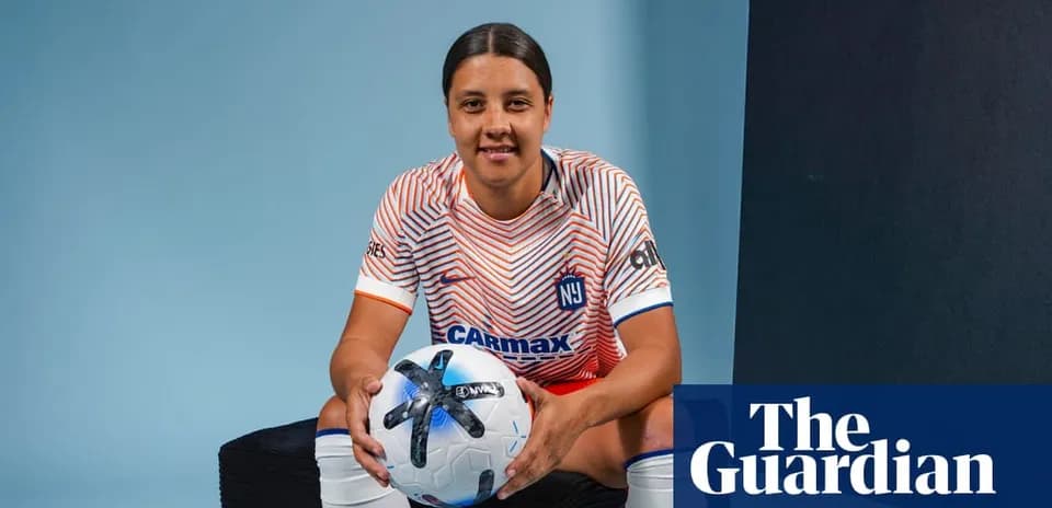 Player posing with soccer ball in studio