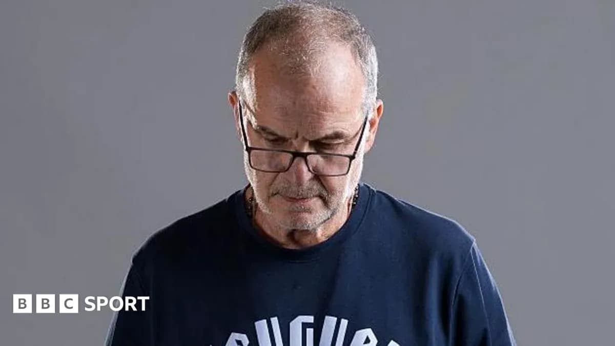 Man wearing glasses looking down thoughtfully