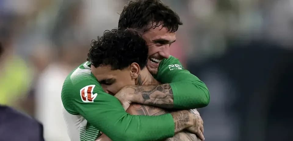 Players celebrating with an embrace after victory