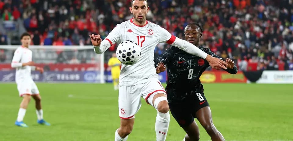Tunisian player controls ball while being challenged