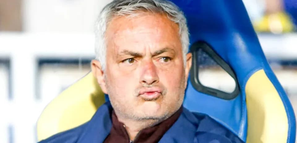 Coach sitting on bench during match
