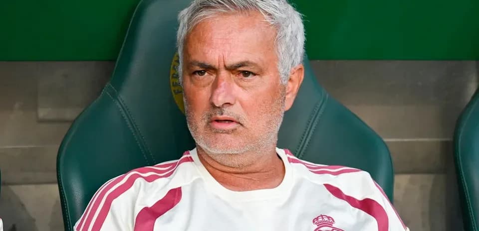 Coach seated on bench during a match