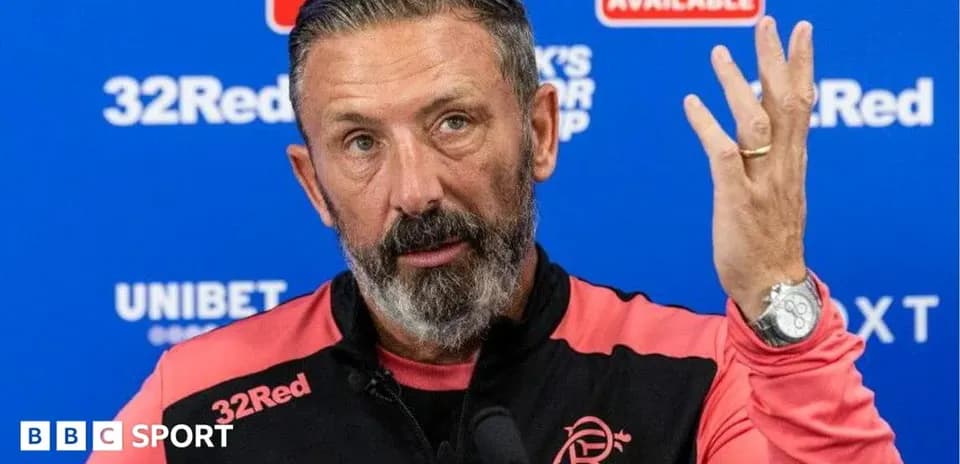 Manager speaking at press conference with raised hand