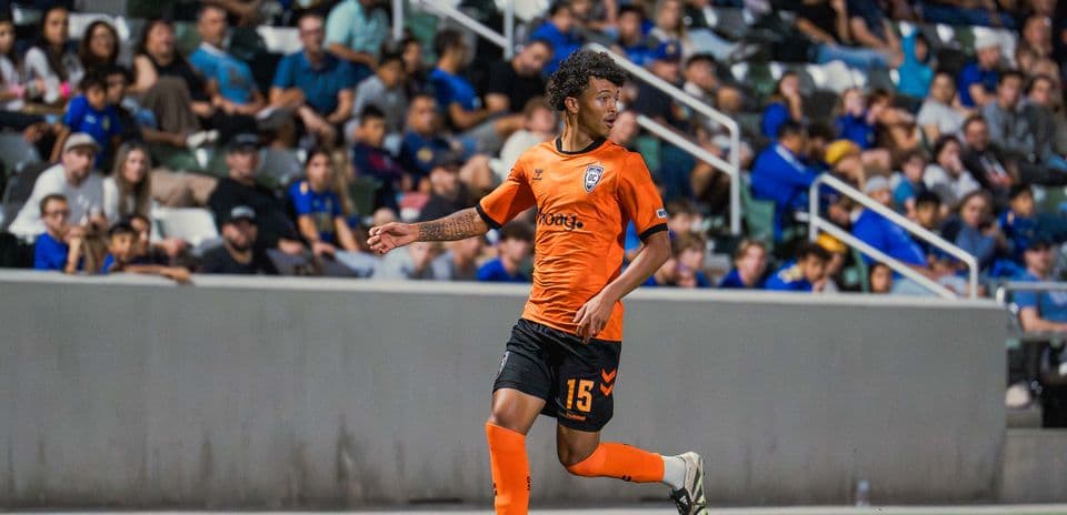 Player in orange jersey during USL match