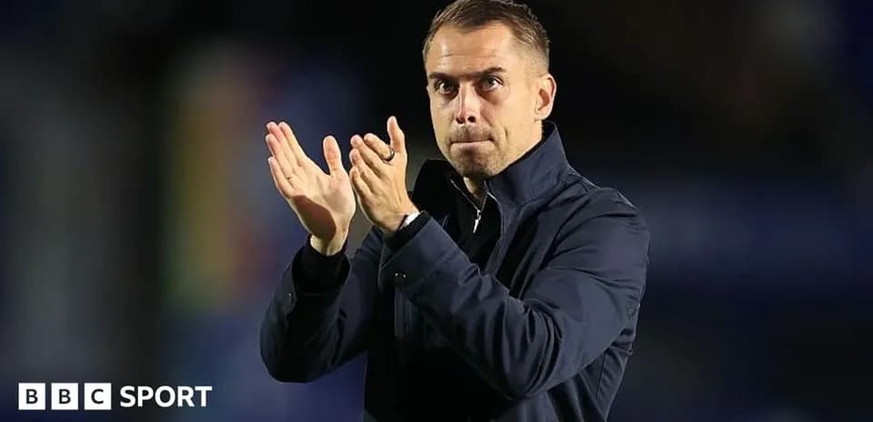 Coach applauding after a match on the sidelines