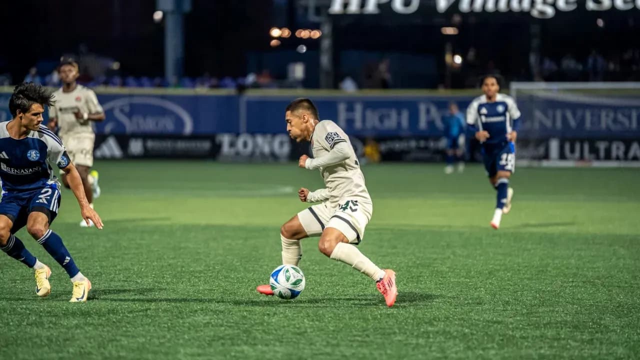 Player dribbling the ball during MLS Next Pro match