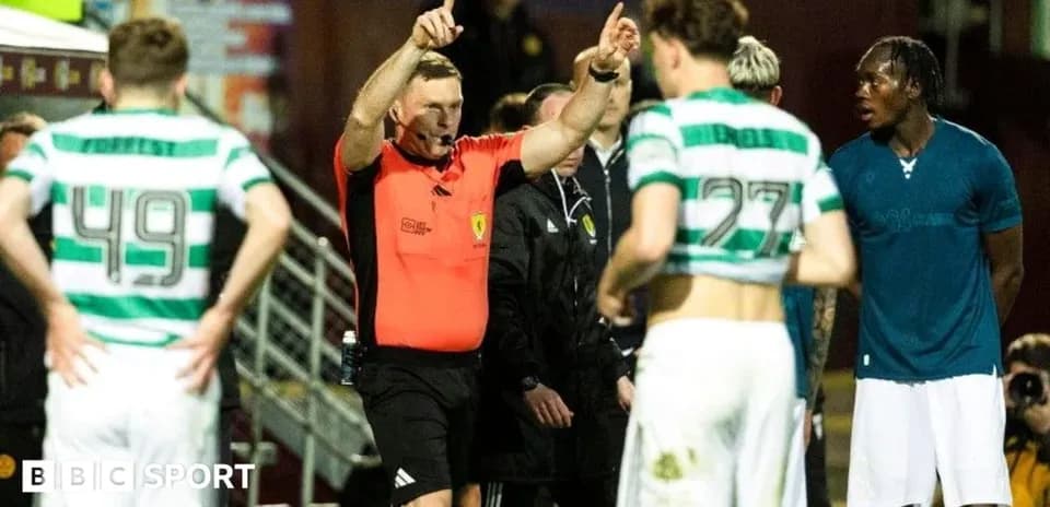 Referee signaling during match with players nearby
