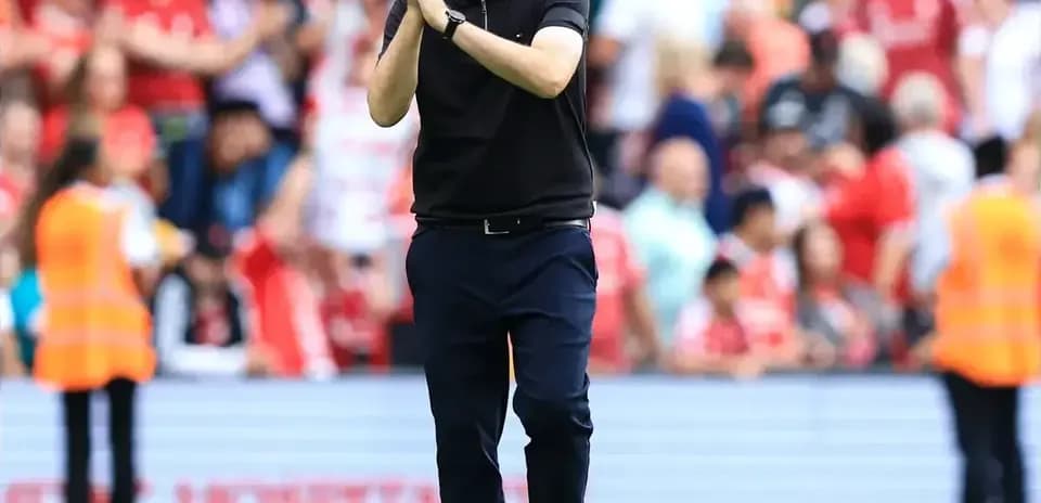Coach applauding fans after the match