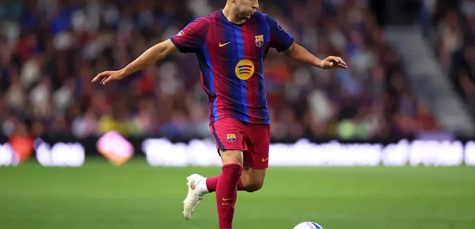 Player in Barcelona kit dribbling soccer ball on field