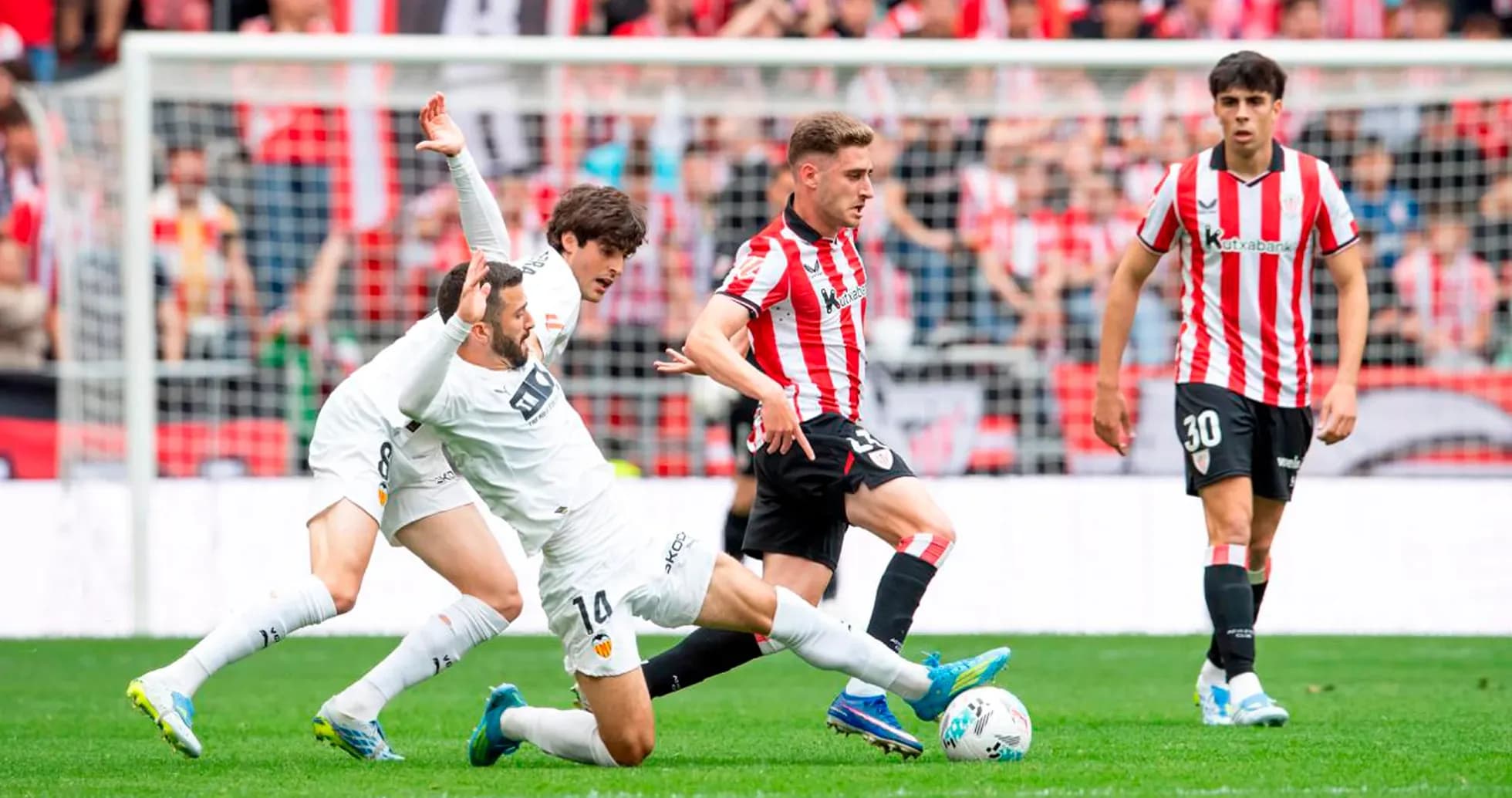 Athletic Club player tackling Valencia opponent