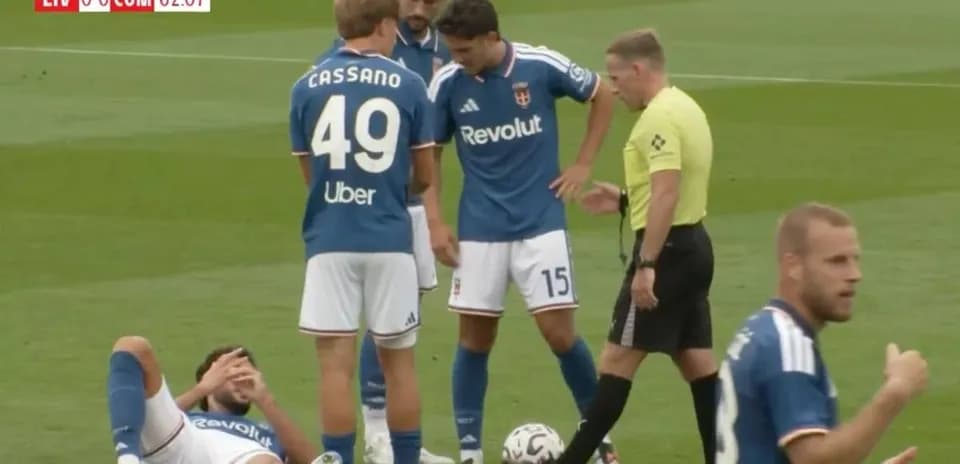 Players and referee discussing an injury on field