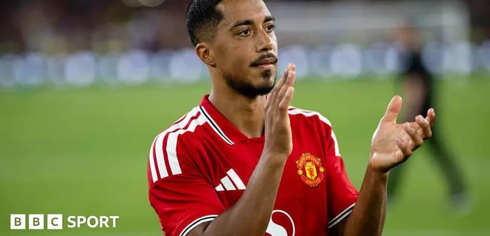 Player applauding fans wearing Manchester United jersey