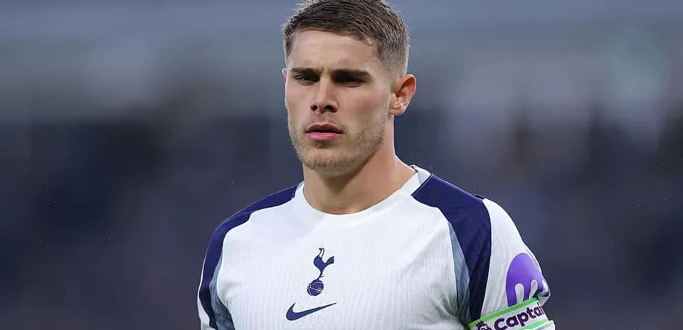 Player wearing Tottenham jersey with captain's armband