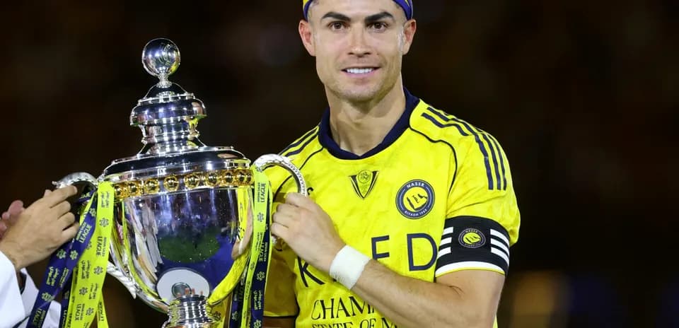 Player holding trophy after winning the match