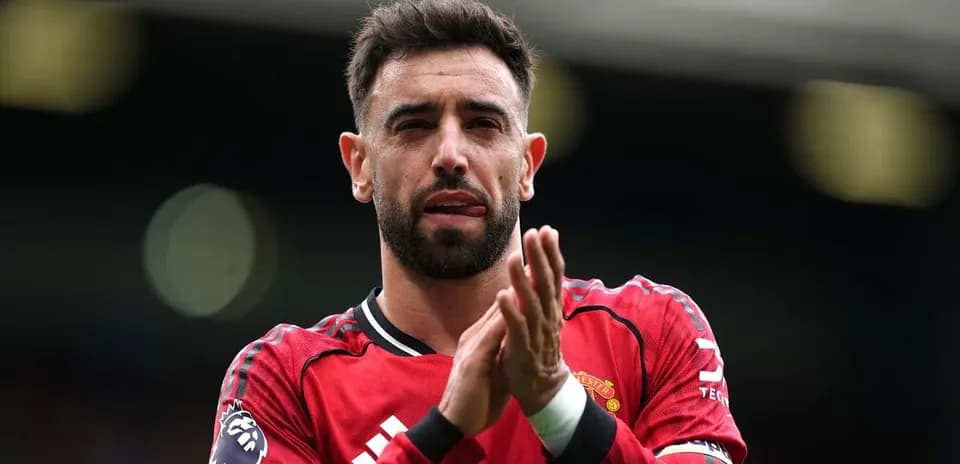 Player applauding fans in Manchester United jersey