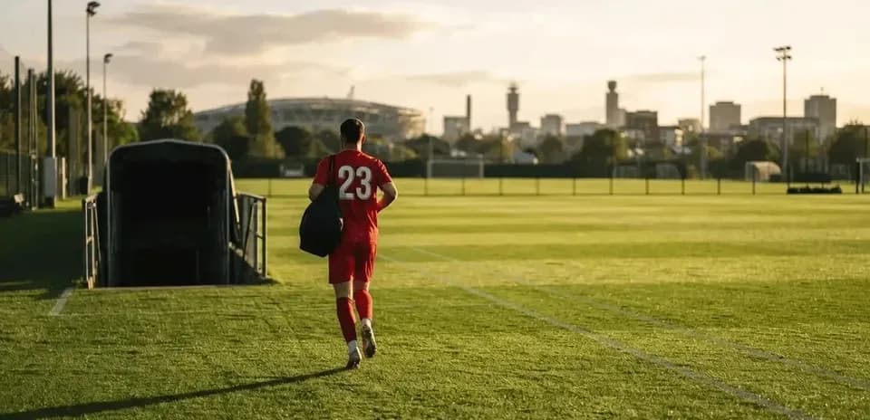 Player in red jersey walking off the pitch