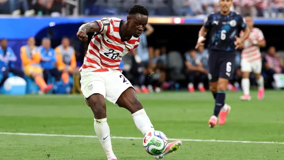 Player in USA kit kicking ball during match