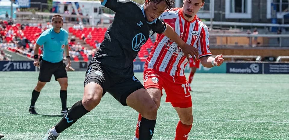 Players competing for the ball in football match
